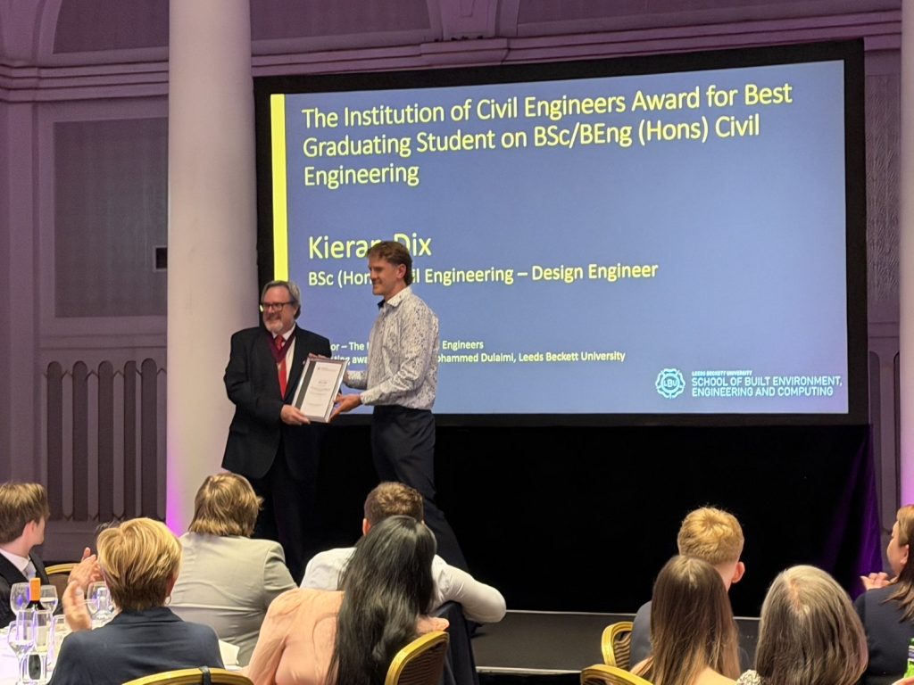Kieran being given his awards after graduation
